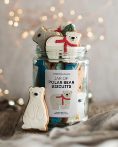 Honeywell Bakes Jar of Polar Bear Biscuits - A glass jar filled with assorted polar bear shaped biscuits, with a single polar bear biscuit standing in front on a rustic surface. The jar label reads 'HONEYWELL BAKES JAR OF POLAR BEAR BISCUITS'.