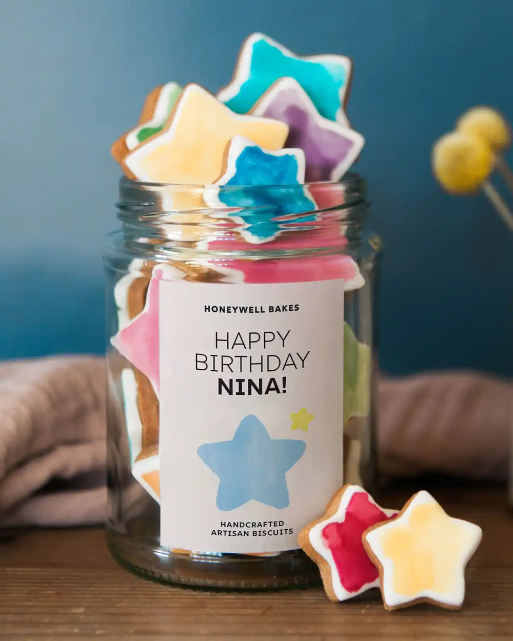 Honeywell Bakes Jar Of You’re A Star Biscuits - Jar of star-shaped cookies with a personalised label on a wooden surface.