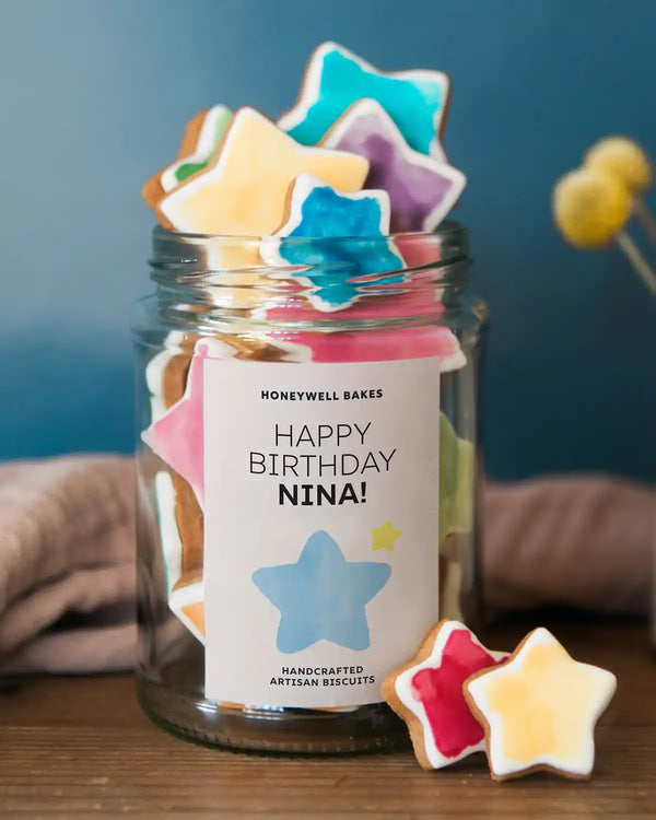 Honeywell Bakes Jar Of You’re A Star Biscuits - Jar of star-shaped cookies with a personalised label on a wooden surface.