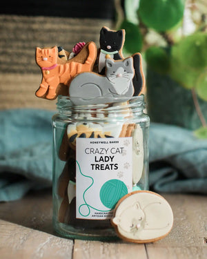 Close-up of the personalised label on a jar of biscuit cats, with a custom message to make a thoughtful cat lover gift.