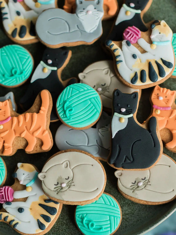 Close-up of adorable cat-shaped biscuits in a jar, perfect for gifting to cat lovers and biscuit fans.