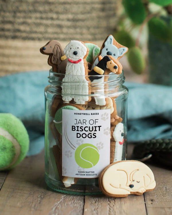 Jars of dog-shaped biscuits with personalised labels, offering thoughtful and unique gifts for dog lovers.