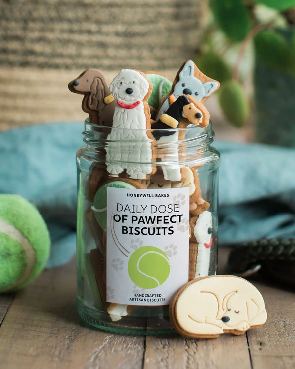 Close-up of the personalised label on a jar of biscuit dogs, featuring a custom message for a unique dog lover gift.