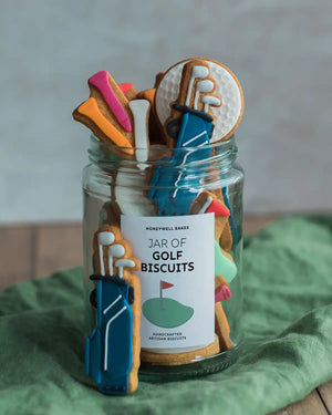 Honeywell Bakes Jar of Golf Biscuit Gift - Jar of golf-themed cookies with decorative elements on a green surface.
