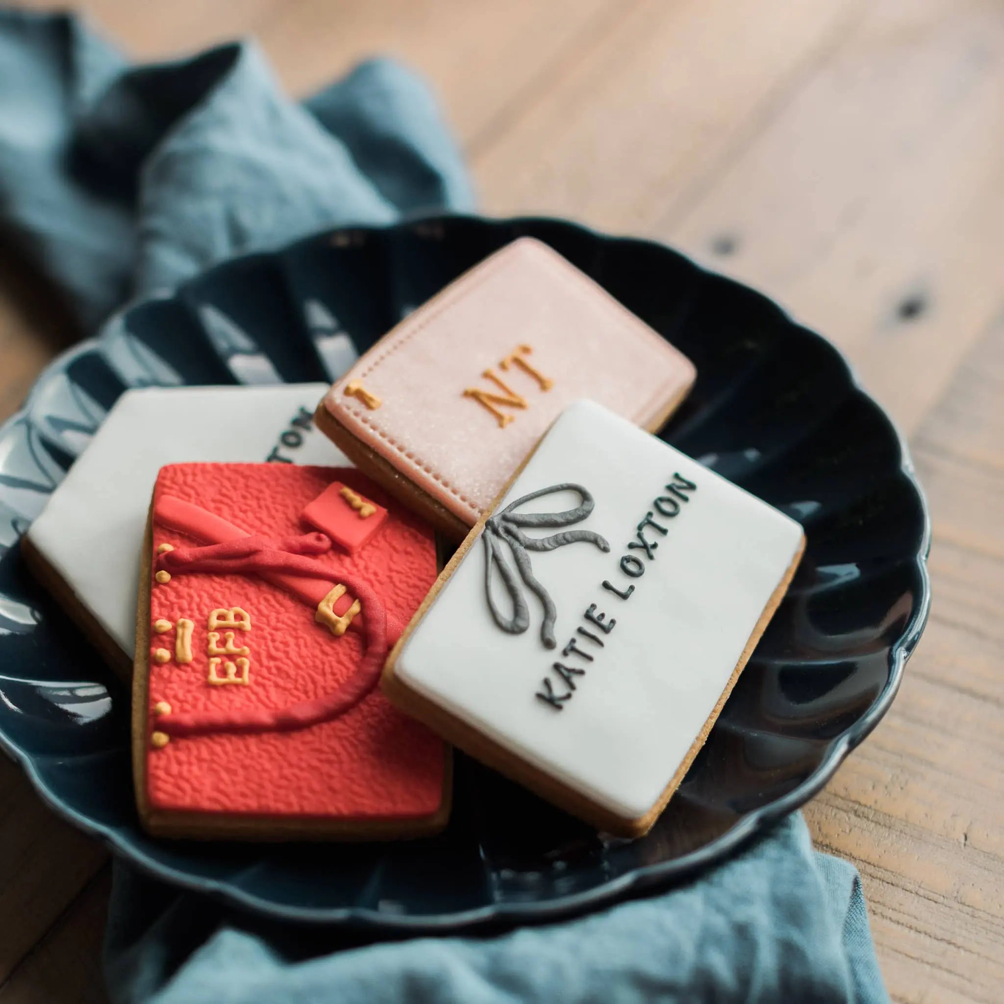 Hand iced handbag biscuits for the brand Katie Loxton, in custom colours 