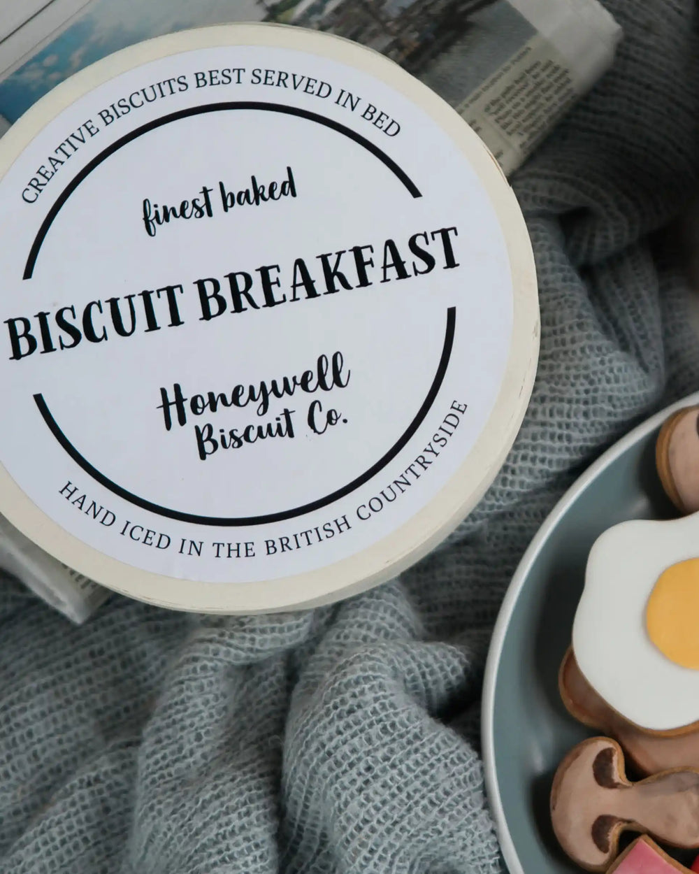 Honeywell Bakes Large Full English Biscuit Breakfast - Breakfast-themed cookies on a plate with a mug of coffee and cutlery on a wooden table.