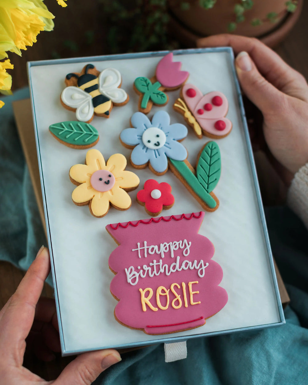 Honeywell Bakes Large Happy Biscuit Bloom Gift - Decorative cookies in a box with 'Happy Birthday Rosie' text, held by hands.