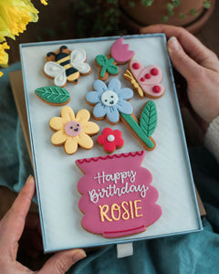 Honeywell Bakes Large Happy Biscuit Bloom Gift - Decorative cookies in a box with 'Happy Birthday Rosie' text, held by hands.