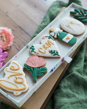 Honeywell Bakes Large Lovely Couple Biscuit Gift Set - Decorative cookies with floral and heart designs on a wooden surface.