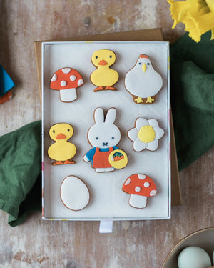 Honeywell Bakes Large Miffy Spring Biscuit Gift Set - Box of decorated cookies shaped like animals and objects on a wooden surface.