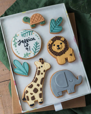 Honeywell Bakes Large Personalised Safari Biscuit Gift - Set of animal-themed cookies in a box with 'Jessica is 9!' on one of them.