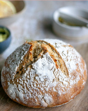 Honeywell Bakes Bread Bakers Subscription, A round artisanal bread loaf dusted with white flour