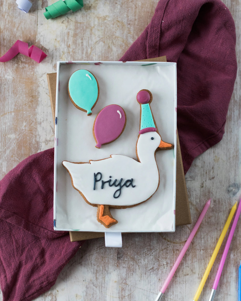 Honeywell Bakes Medium Party Duck Biscuit Gift - Decorative cookie shaped like a duck with balloons in a gift box