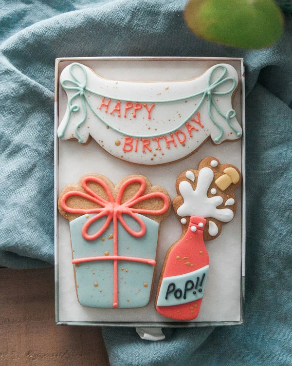 Honeywell Bakes Medium Happy Birthday Biscuit Gift - Cookies shaped like a birthday banner, champagne bottle and present. Personalised.