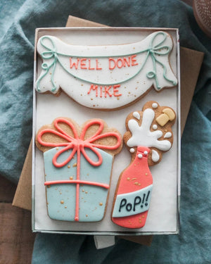 Honeywell Bakes Medium Happy Birthday Biscuit Gift - Cookies shaped like a birthday banner with Well Done Mike, champagne bottle and present. Personalised.