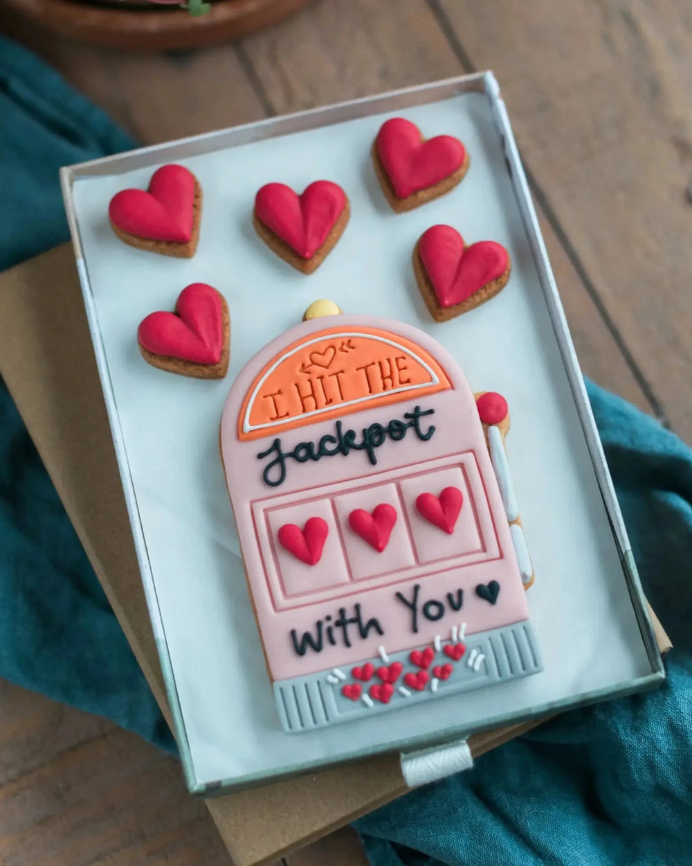  Honeywell Bakes Medium I Hit The Jackpot With You Biscuit Gift - Gift box with a pink slot machine cookie and red heart cookies, held by two hands.