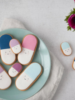 Honeywell Bakes Medium get well soon biscuit gift - Decorative cookies shaped like pills on a plate with a floral background
