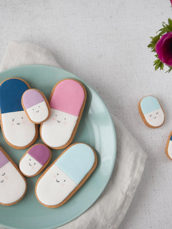 Honeywell Bakes Medium get well soon biscuit gift - Decorative cookies shaped like pills on a plate with a floral background