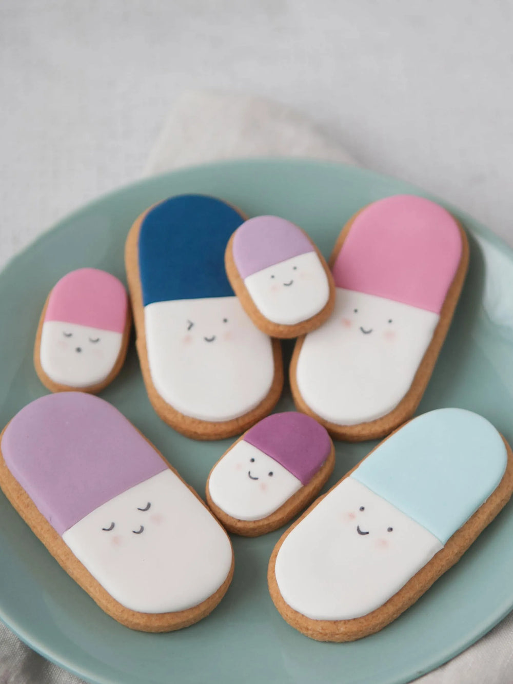 Honeywell Bakes Medium get well soon biscuit gift - Decorative cookies with white icing and colourful accents on a green plate