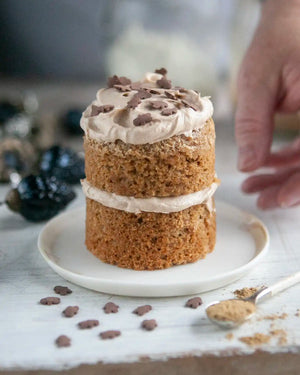 Honeywell Bakes Mini Gingerbread Cake Kit - Two-layer gingerbread cake with buttercream and sprinkles on a white plate.