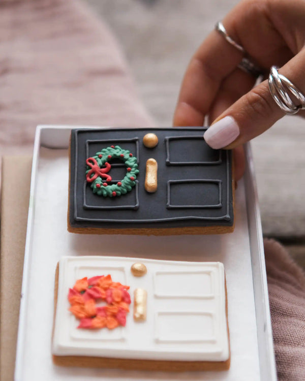 Honeywell Bakes New Home Biscuit Gift Set - Decorative cookies shaped like a front door with festive wreaths on a white box.