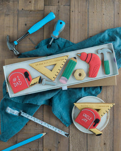 Honeywell Bakes No One Else Measures Up Biscuit Gift - Decorative cookies shaped like tools and measuring instruments on a wooden surface with a blue towel.