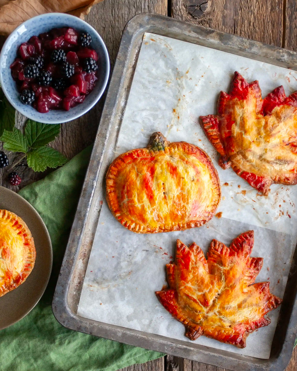 Honeywell Bakes - A tray of autumn inspired hand shaped pies on a table surrounded by a bowl of blackberries on a wooden table