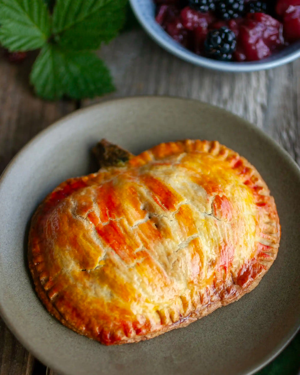 Honeywell Bakes - A tray of autumn inspired hand shaped pies on a table surrounded by a bowl of blackberries on a wooden table