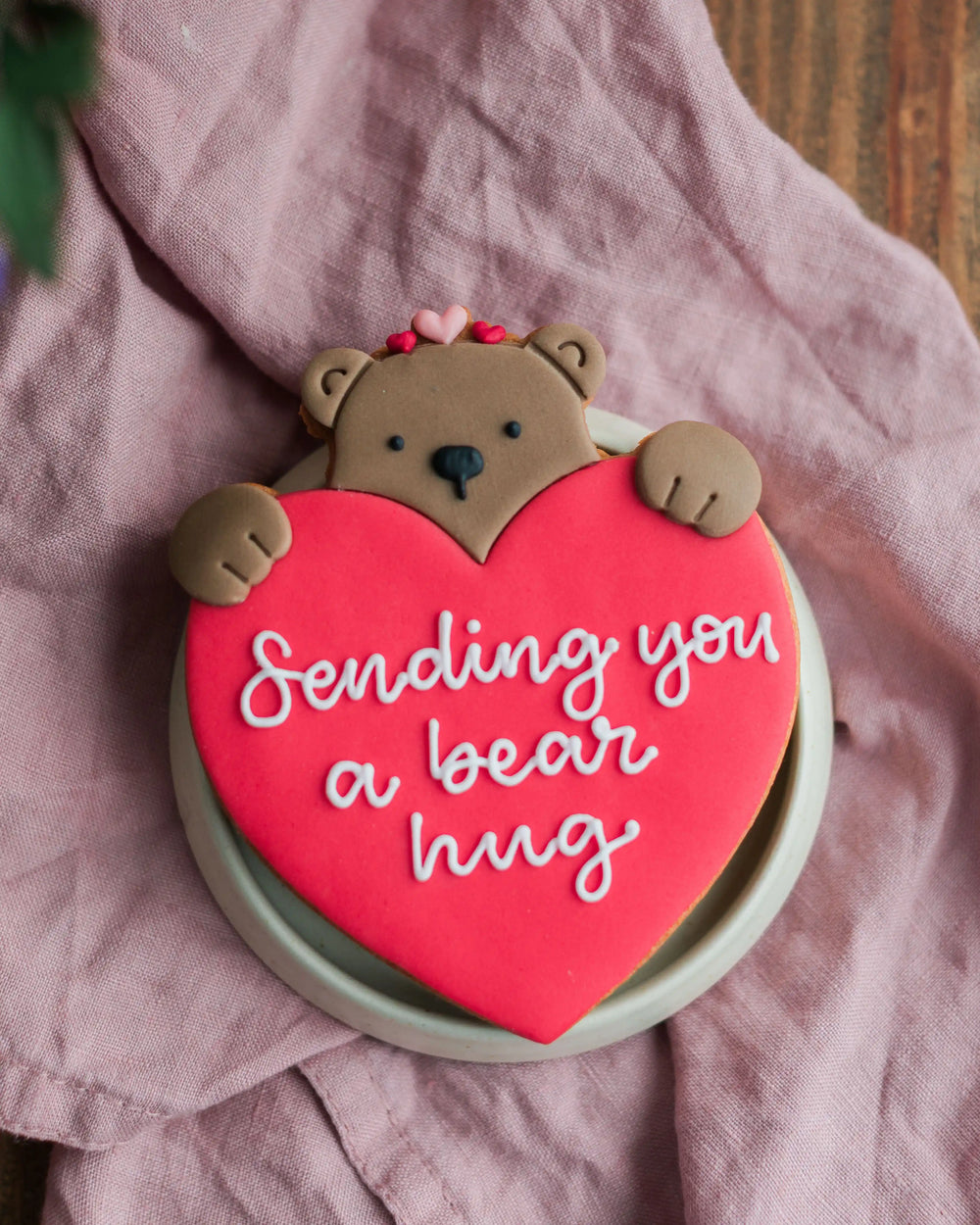 Honeywell Bakes Personalised Bear Hug Biscuit - large biscuit bear holding a heart with ‘Sending you a bear hug’ text.