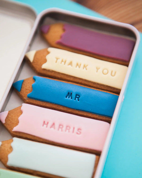 Honeywell Bakes Personalised Biscuit Pencils in Pencil Tin - Decorative cookies shaped like pencils with personalised text in a tin box.