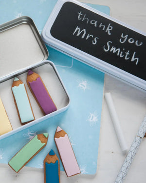 Honeywell Bakes Personalised Biscuit Pencils in Pencil Tin - Decorative cookies shaped like pencils in a tin with 'thank you Mrs Smith' on a chalkboard lid.