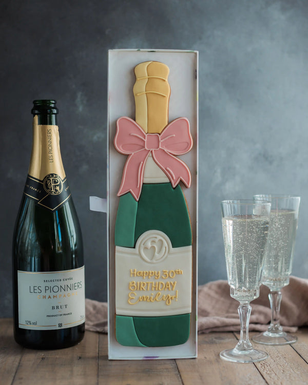 Honeywell Bakes Personalised Champagne Biscuit Bottle - Green - Large celebration champagne bottle biscuit personalised next to a real sized champagne bottle