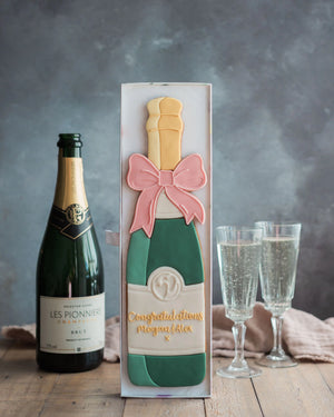 Honeywell Bakes Personalised Champagne Biscuit Bottle - Green - Large celebration champagne bottle biscuit personalised next to a real sized champagne bottle