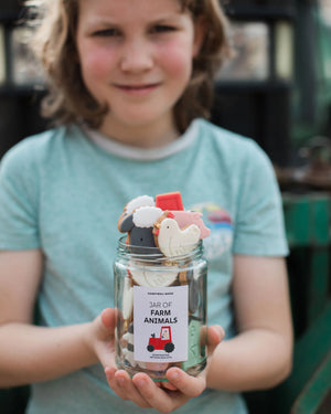 Honeywell Bakes Personalised Jar of Farm Animal Biscuits - Child holding a jar of farm animal biscuits with a blurred background
