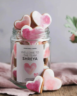 Honeywell Bakes Personalised Jar of Heart Biscuits - Jar of heart-shaped cookies with a personalised label on a wooden surface.