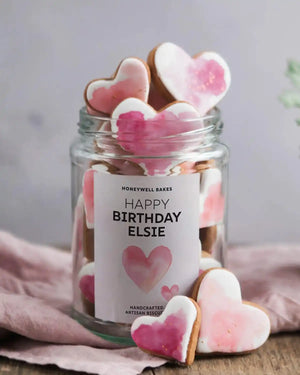 Honeywell Bakes Personalised Jar of Heart Biscuits - Jar of heart-shaped cookies with a personalised label on a wooden surface.