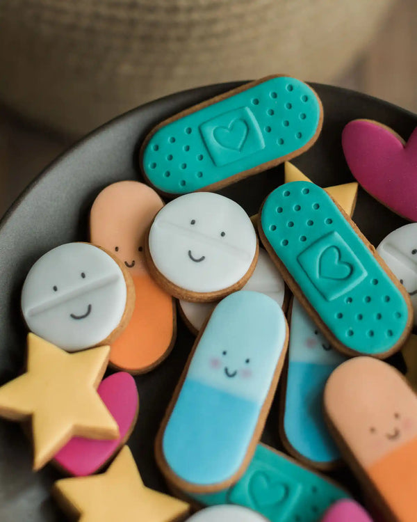 A jar of colourful smiley face and heart biscuits, designed as a personalised feel-good gift to brighten someone's day.