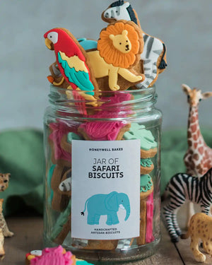 Honeywell Bakes Personalised Jar of Safari Biscuits - Jar of safari-themed cookies with animal figurines on a wooden surface.