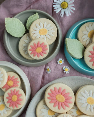 Honeywell Bakes Personalised Jar of Shortbread Daisies - Decorative cookies with floral designs on a pink fabric background