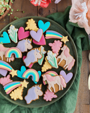 Honeywell Bakes Personalised Jar of Unicorn Biscuits - A plate of colourful unicorn themed biscuits on a green plate