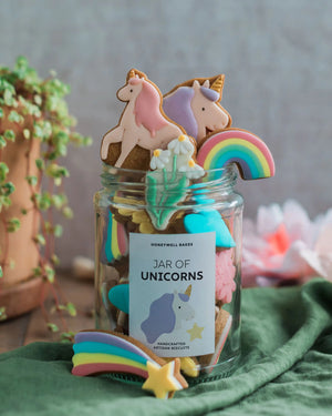 Honeywell Bakes Personalised Jar of Unicorn Biscuits - Jar of unicorn-themed cookies with a decorative label on a green surface.