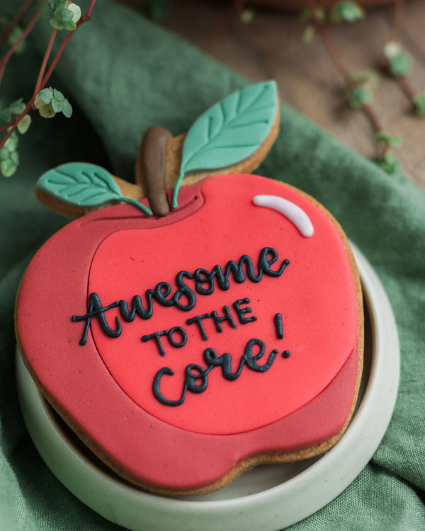Honeywell Bakes Personalised Thank You Teacher Apple Biscuit - Cookie shaped like an apple with 'Awesome to the core!' text on a green background