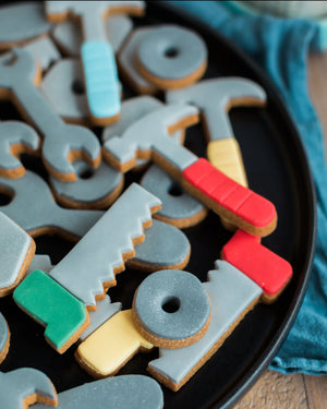 Honeywell Bakes Jar of Tools - Decorative cookies shaped like tools on a black plate with a blue cloth background.