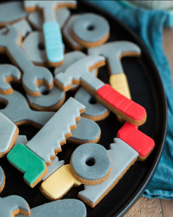 Honeywell Bakes Jar of Tools - Decorative cookies shaped like tools on a black plate with a blue cloth background.
