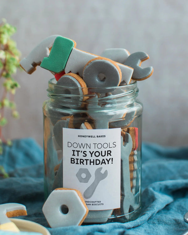 Honeywell Bakes Personalised Jar of Tools - Jar of cookie tools with a birthday message on a blue fabric background