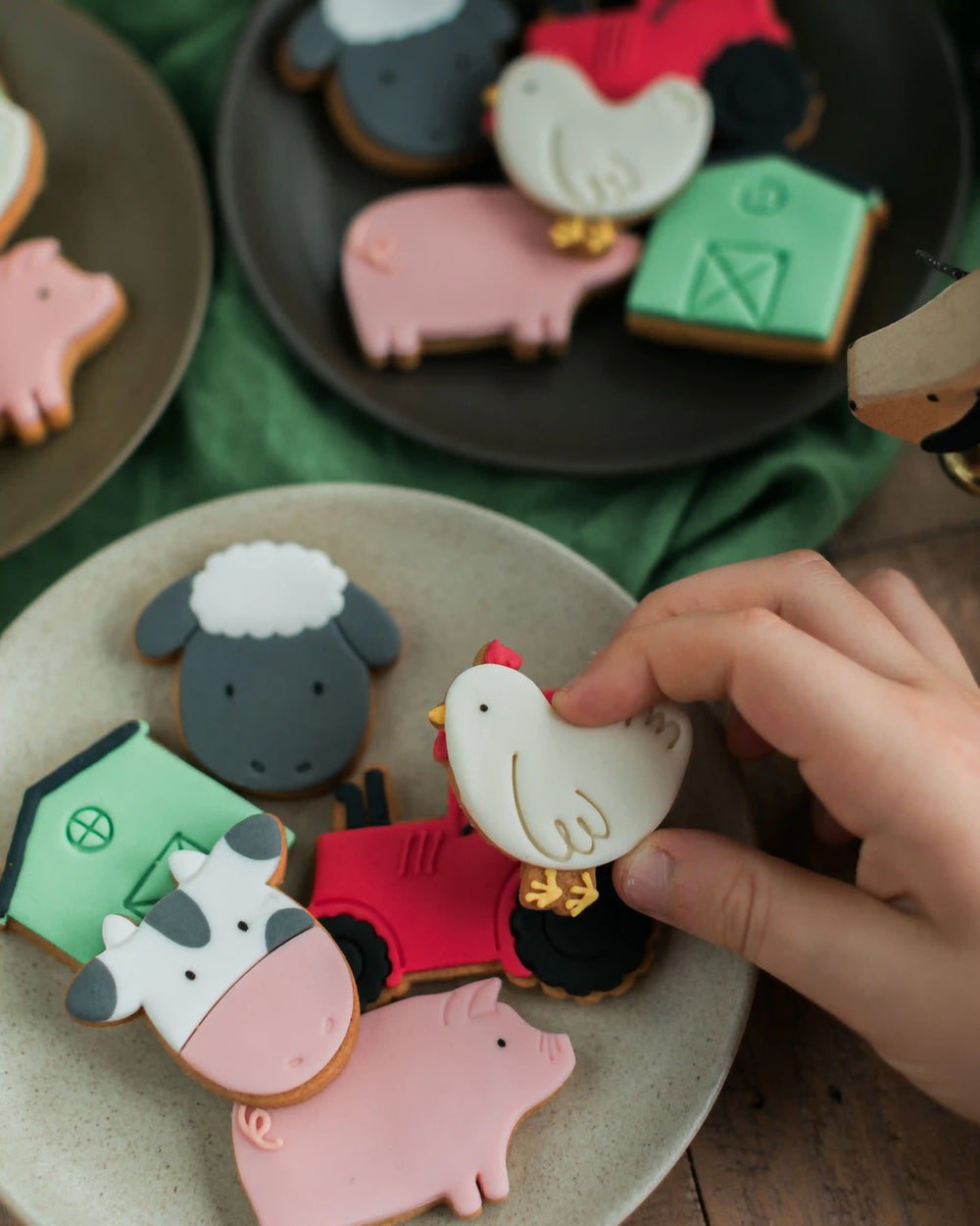 Honeywell Bakes Personalised Jar of Farm Animal Biscuits - Jar of cookies shaped like a red tractor, pig, and cow on a wooden surface.
