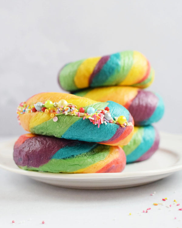 Honeywell Bakes Rainbow Bagel Bread Kit Colourful bagels stacked on a plate with sprinkles