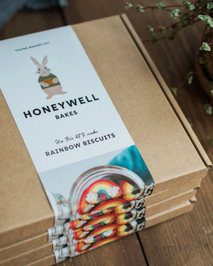 Honeywell Bakes Rainbow Biscuit Baking Kit packaging with a label on a wooden surface