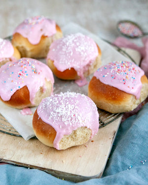 Honeywell Bakes Young Bakers Subscription, Six iced buns with pink icing, topped with shredded coconut and colourful sprinkles