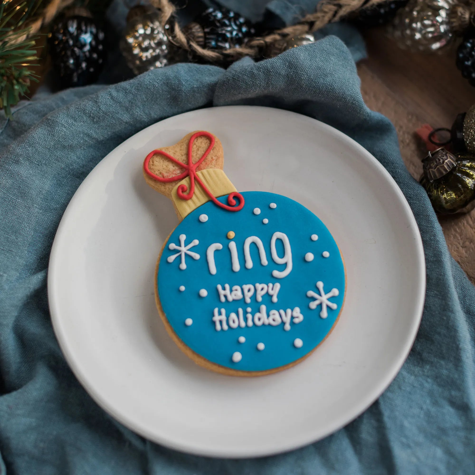 Honeywell Bakes branded festive biscuit, A decorated ornament cookie, branded with Ring logo and hand iced text